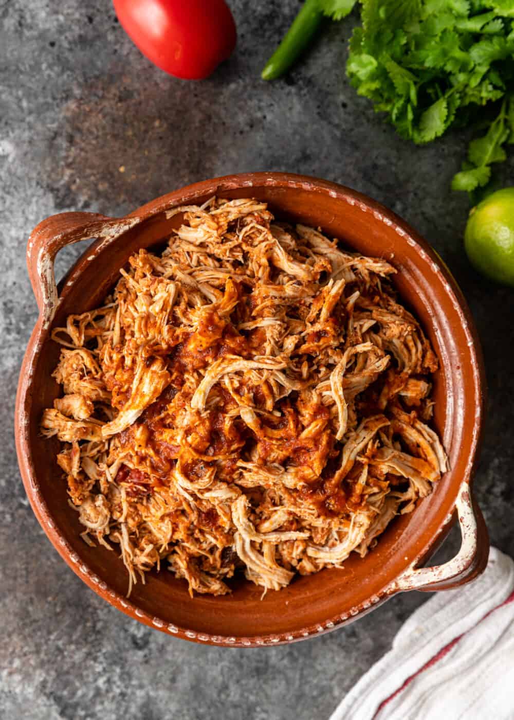 overhead: bowl of pressure cooked spicy shredded chicken
