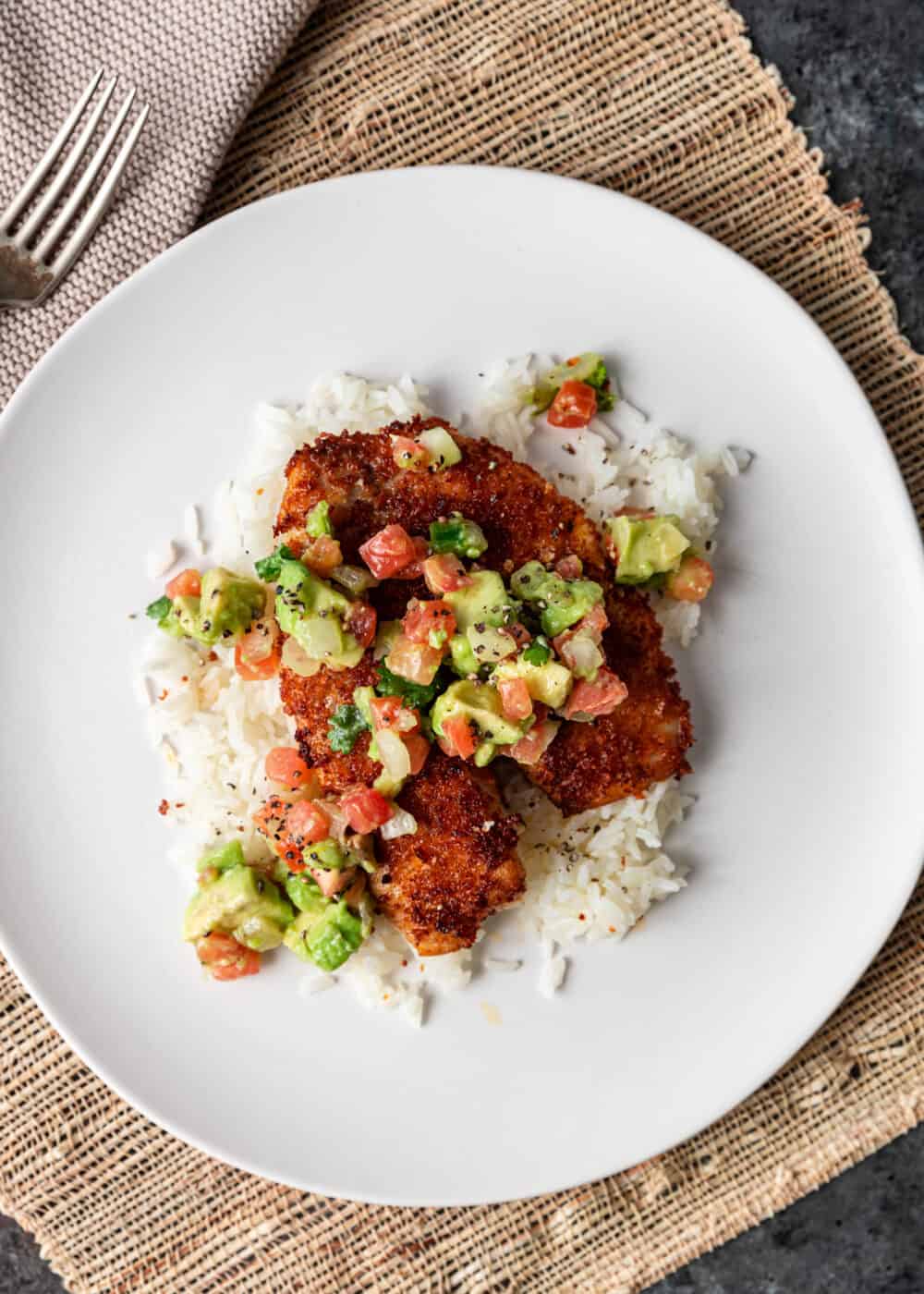 tilapia with avocado salsa on a bed of rice