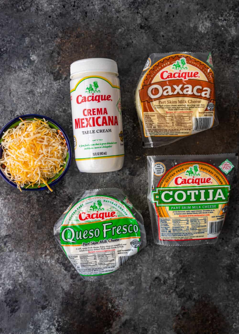queso fresco, cotija, shredded cheese, crema mexicana cheese and oaxaca cheese on counter
