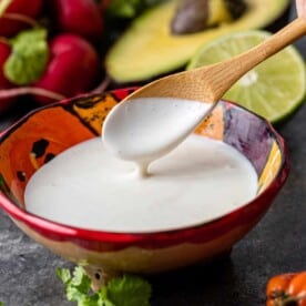 mexican crema in bowl with wooden spoon