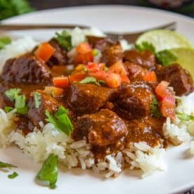 carne adovada succulent pork in red chili sauce with tomatoes and rice
