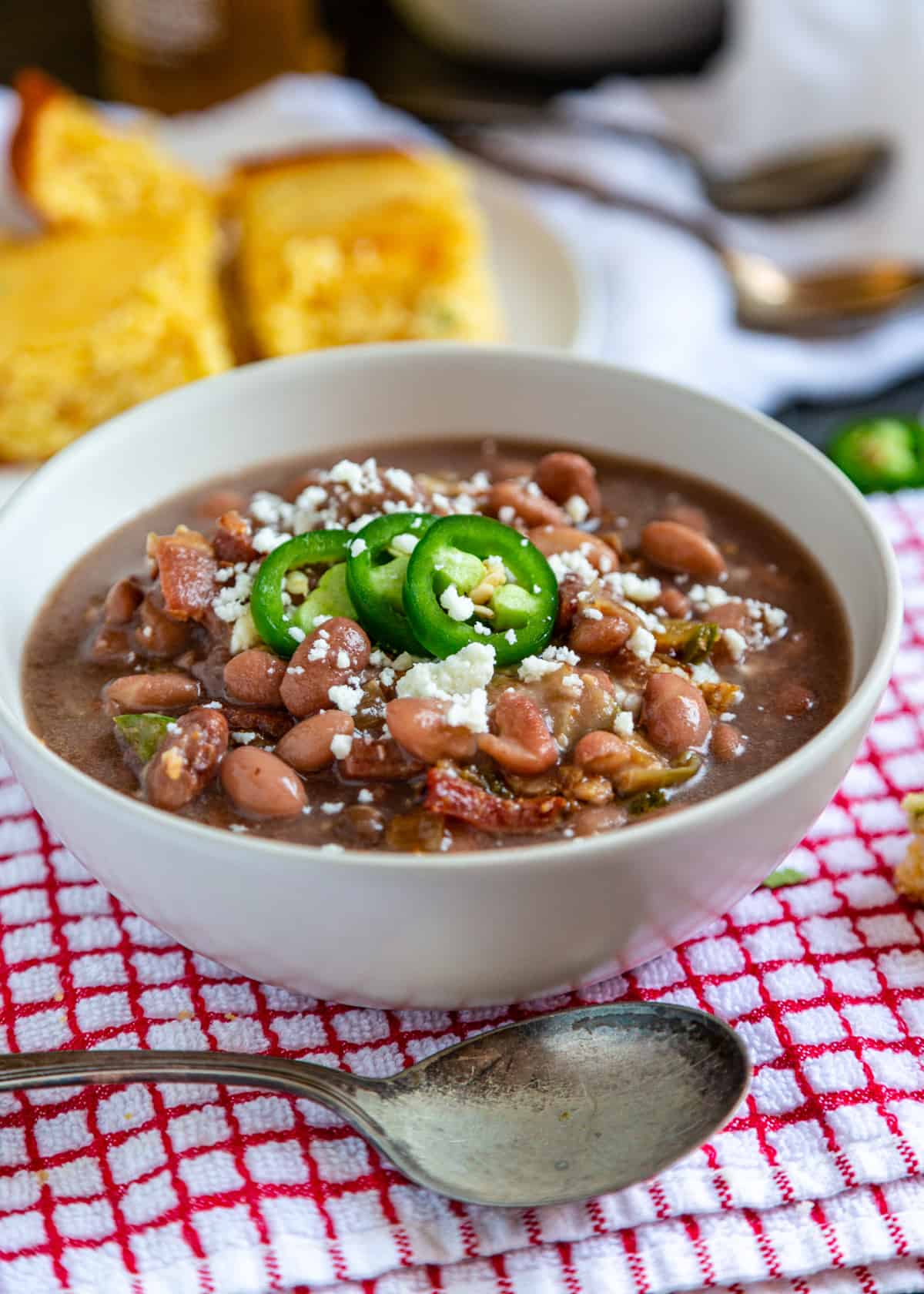 bowl filled with cowboy beans and garnished with jalapeno slices