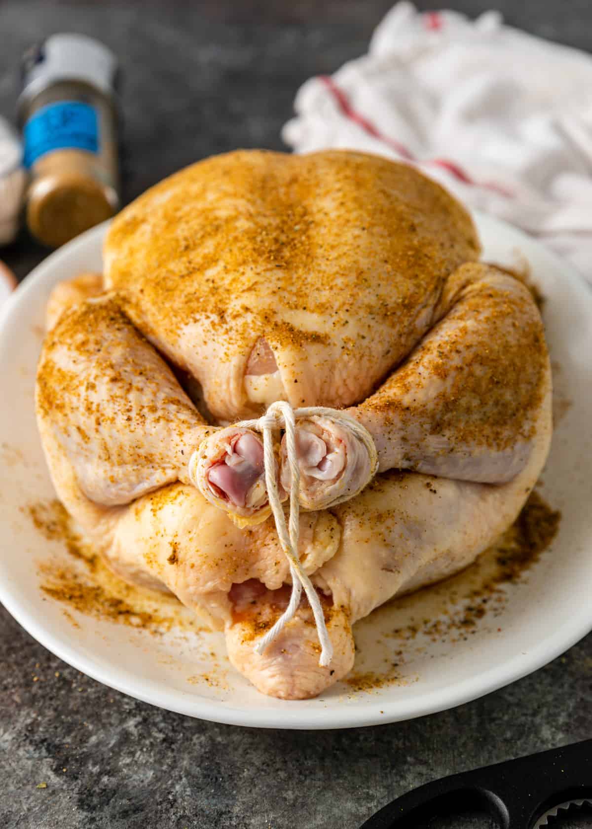 raw chicken with legs tied