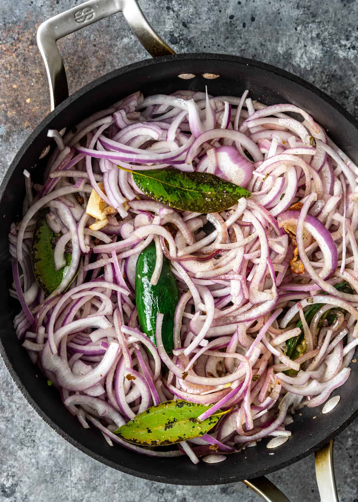 adding red onions to skillet