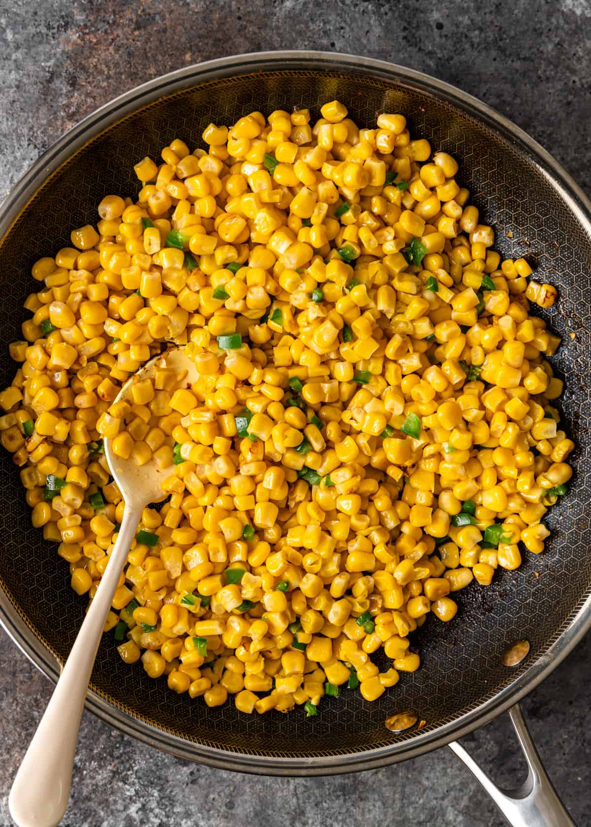 overhead: roasting corn and jalapenos in a skillet