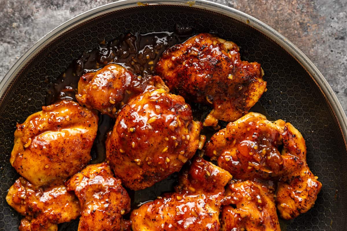 overhead: pan seared habanero apricot chicken in a skillet