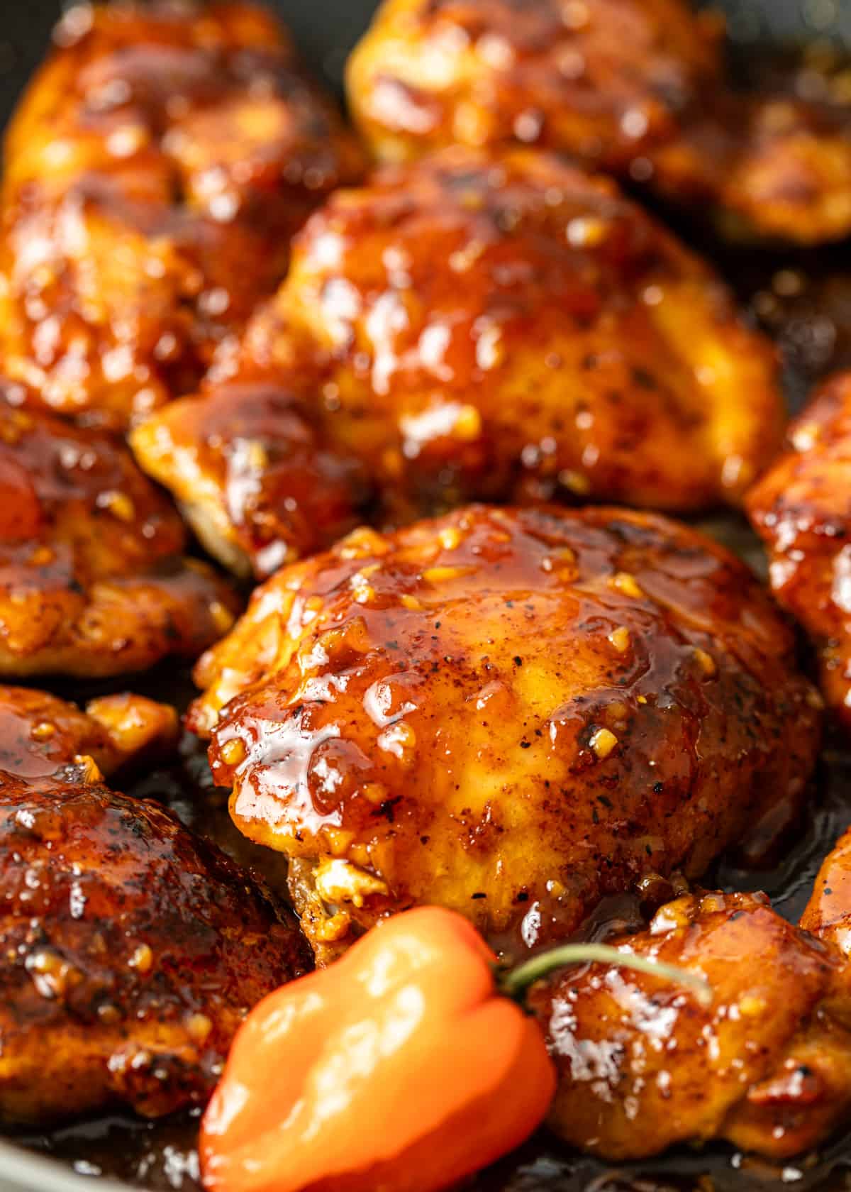 closeup: habanero apricot chicken covered in sauce