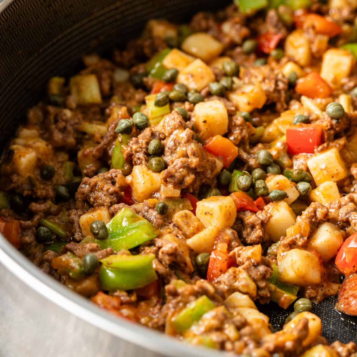 closeup: beef picadillo cooking in a pan