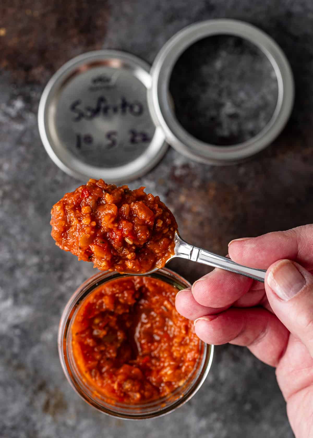 processed red sofrito from canned jar on spoon