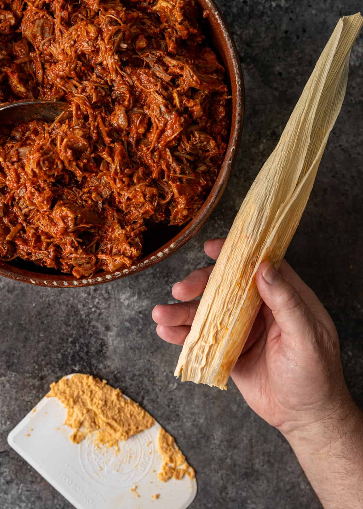 overhead: folding the tamales rojo to close