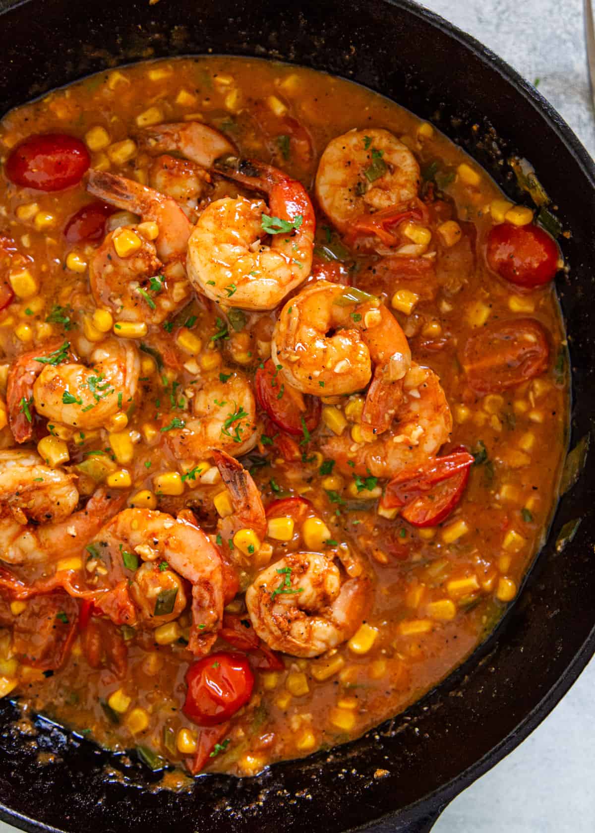 overhead: shrimp and grits cooking in a skillet