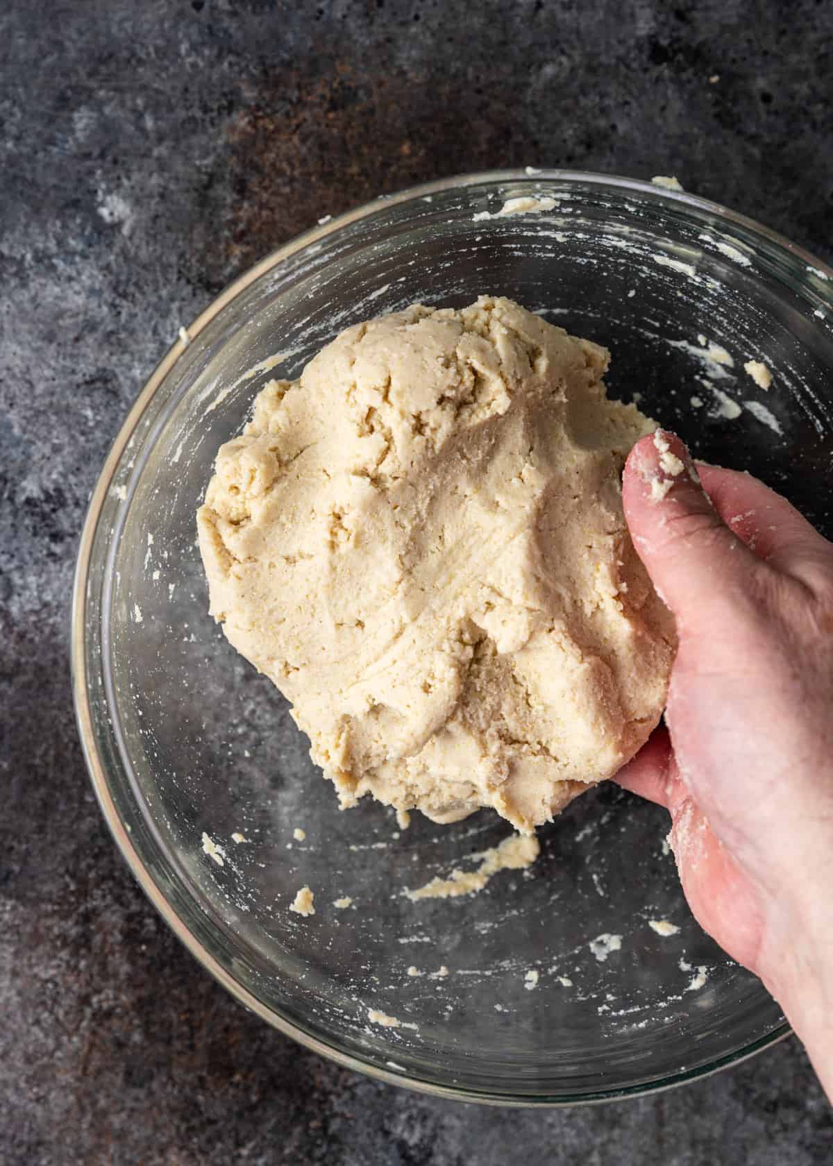 overhead: a hand forming corn tortilla dough